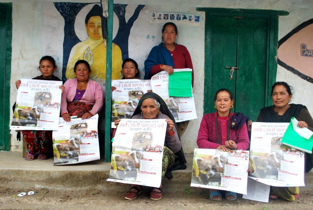 Local women with red panda posters